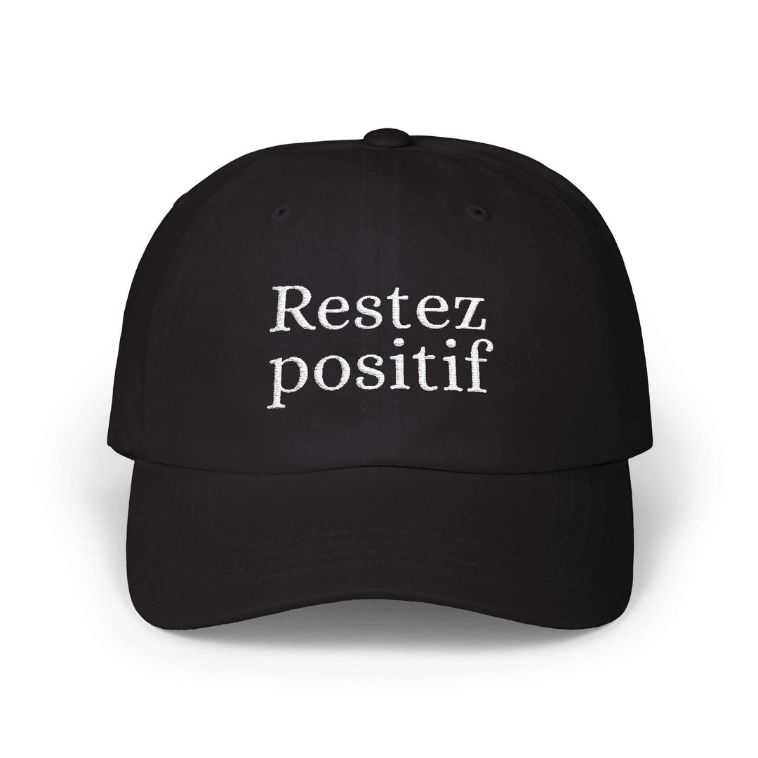 Black Stay Positive Cap with French "Restez positif" embroidery and adjustable strap closure