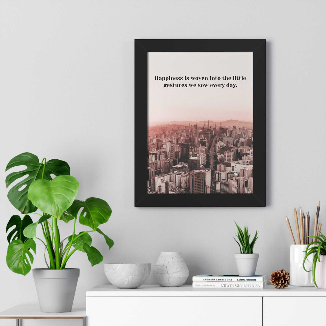 Framed Happiness poster with inspirational quote and cityscape, displayed above a white cabinet with plants and decor.
