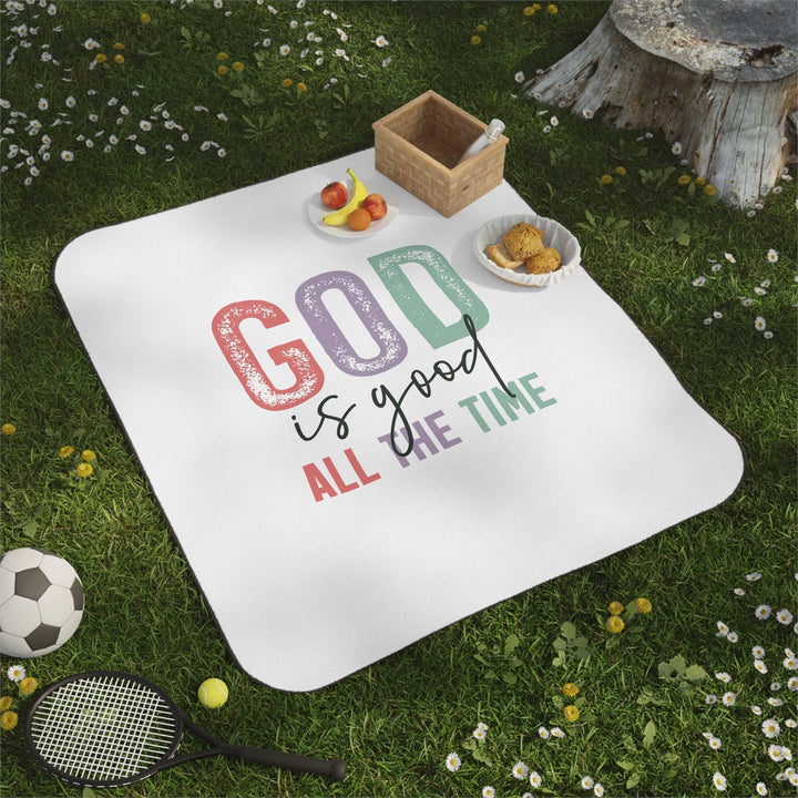 Christian picnic blanket with positive quote "God is good all the time" on soft white fleece, perfect for outdoor use with water-resistant backing and carrying strap