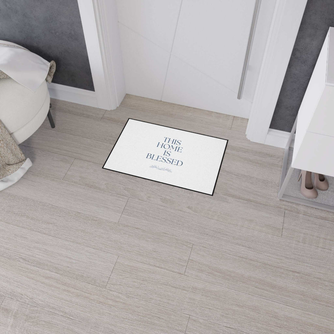 Blessed Home Floor Mat with non-slip backing and black trim placed indoors in front of a white door on light wood flooring