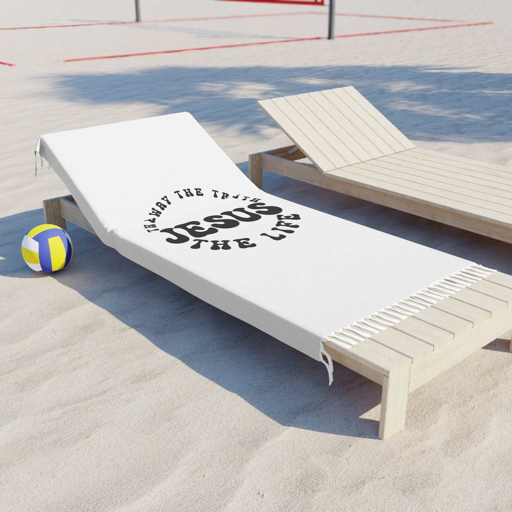 White Jesus Beach Cloth with knotted tassels on lounge chair at the beach