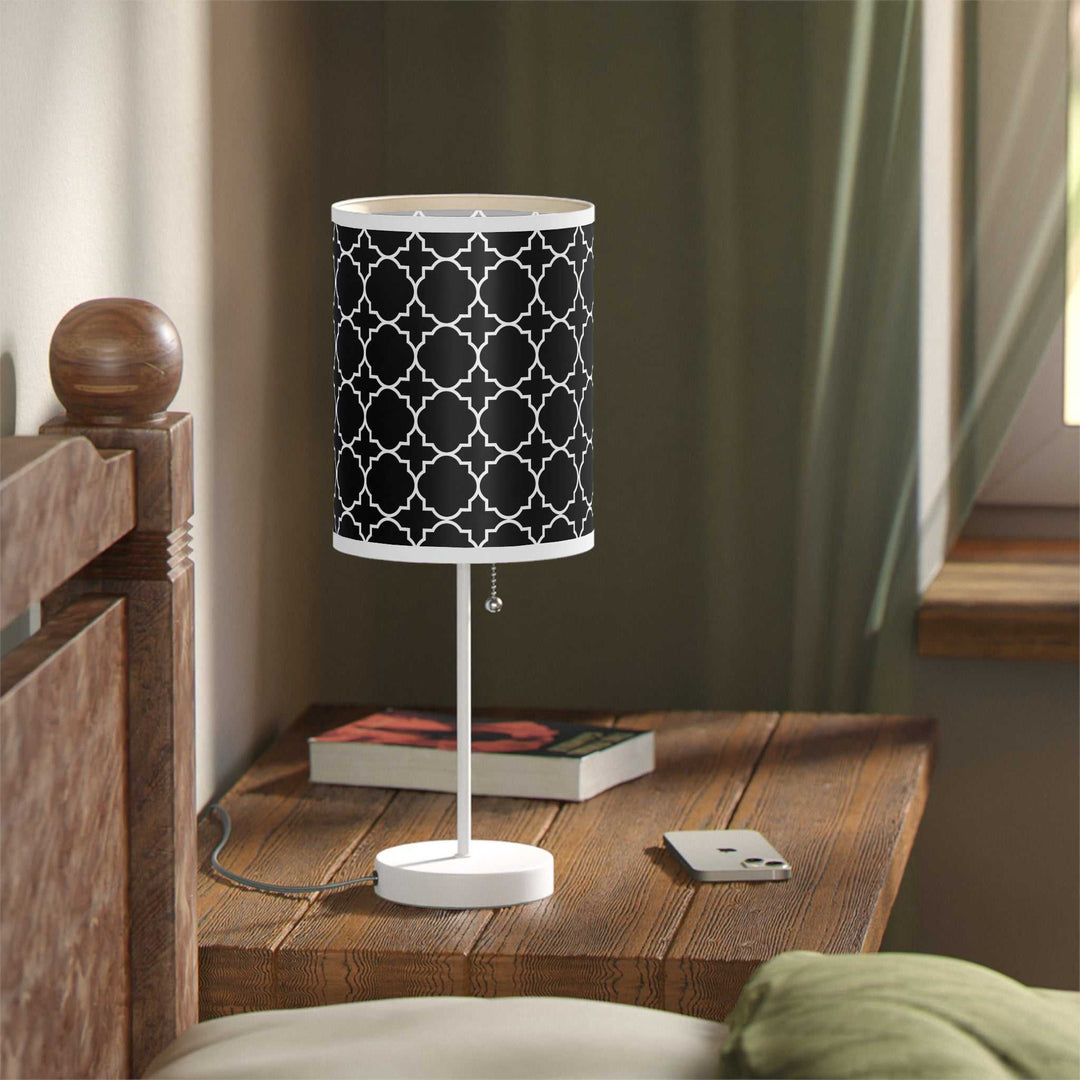 Faith Design Lamp with white steel base and black high-res printed shade with geometric pattern on wooden bedside table