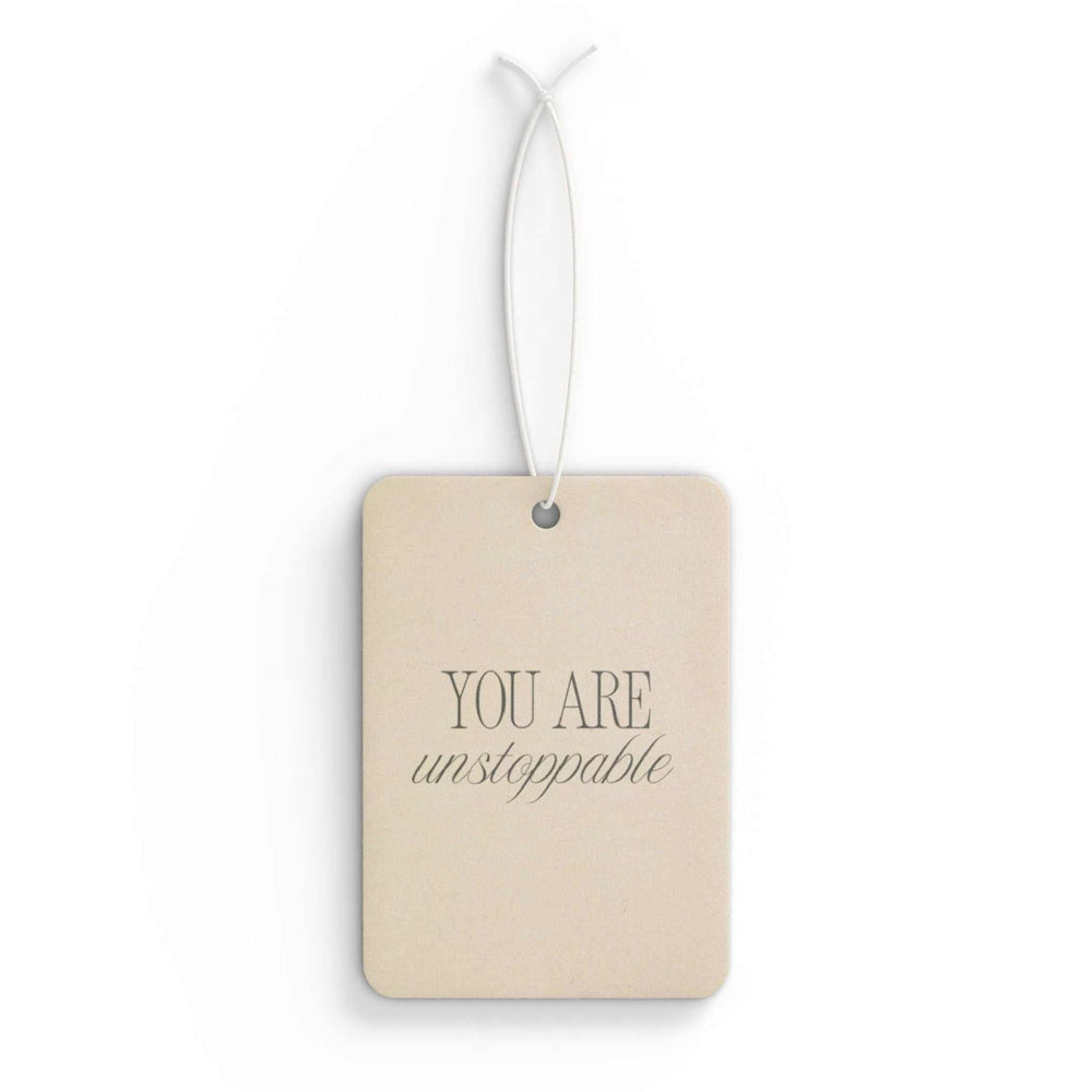 Car air freshener with "You Are Unstoppable" text, available in Pine, New Car, and Black Ice scents