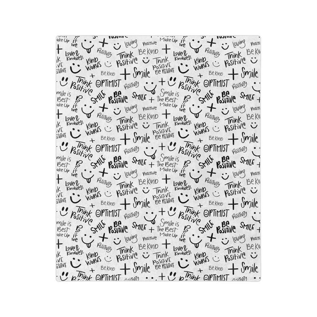 Think Positive Blanket with black positive words and smiley faces on white fleece fabric, soft and cozy with stitched edges