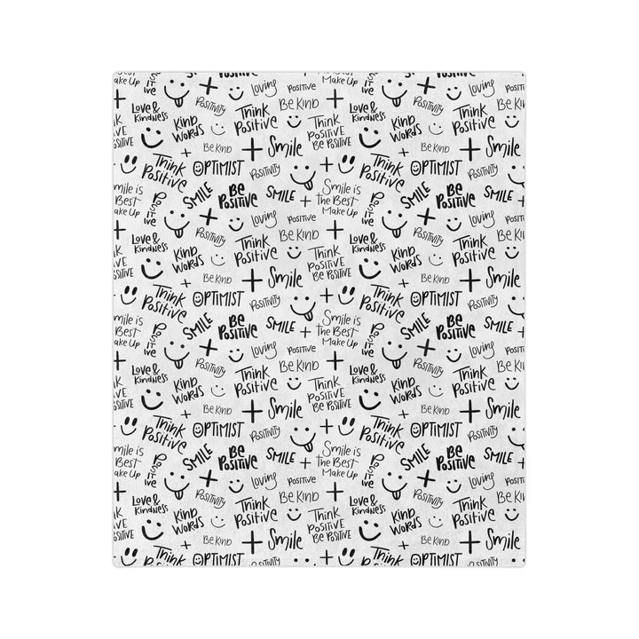 Think Positive Blanket with black positive words and smiley faces on white fleece fabric, soft and cozy with stitched edges