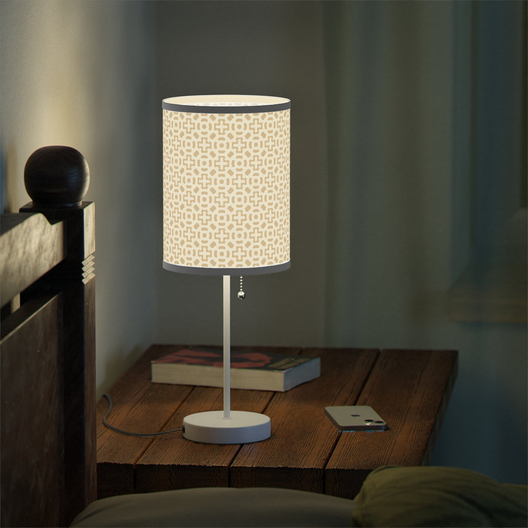 Cross Design Lamp with steel white base and high-resolution printed shade with beige cross pattern on wooden bedside table