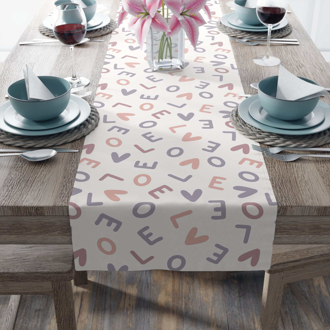 Love Pattern Table Runner with heart and letter design on wooden dining table with pink flowers and tableware