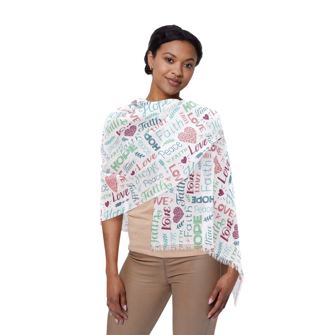 Woman wearing a long, lightweight Faith Light Scarf with inspirational words and colorful text patterns on white background