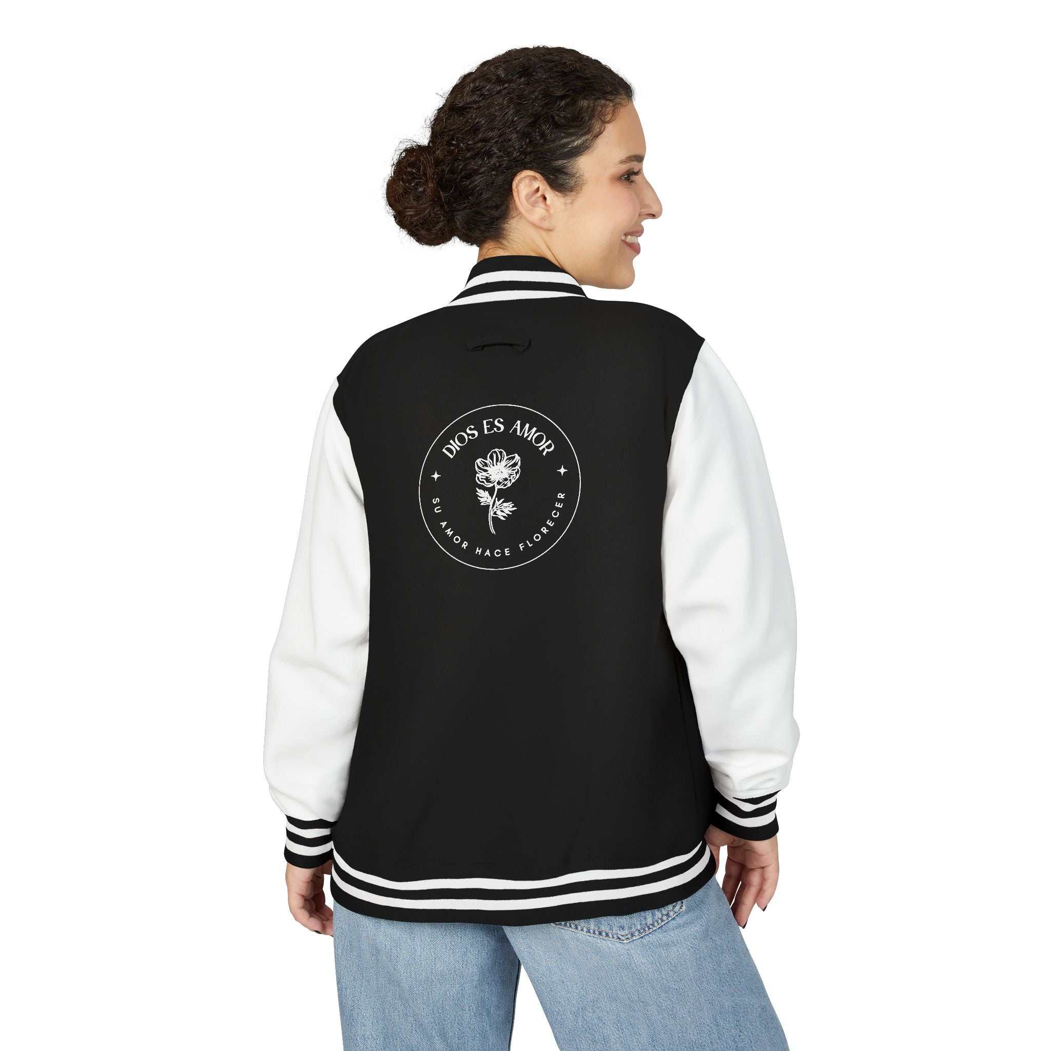 Black and white Dios Es Amor jacket with floral faith design on back, worn by woman