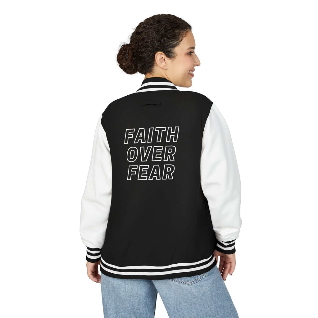 Woman wearing black and white "Faith Over Fear" varsity jacket with cotton blend fabric and striped cuffs