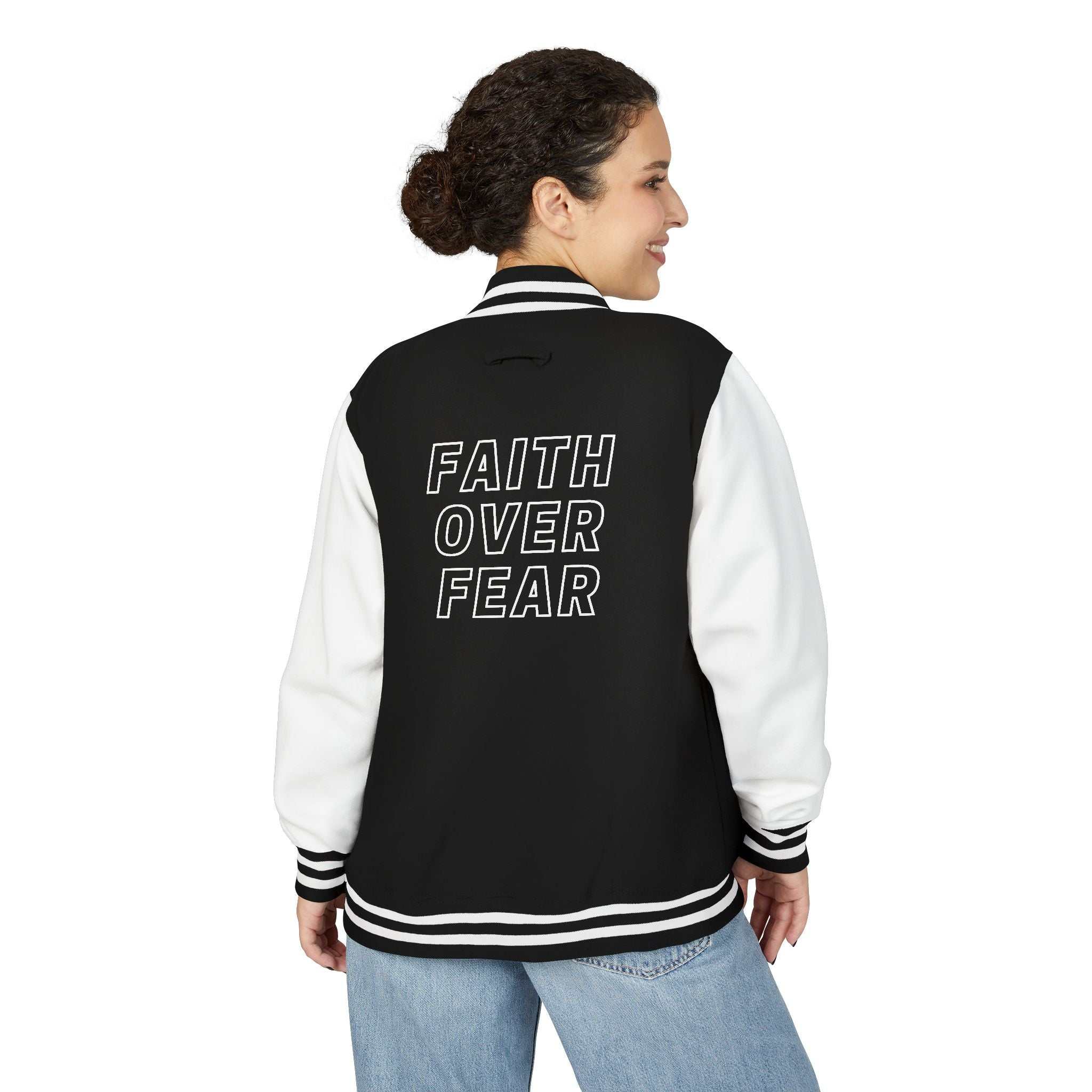 Woman wearing black and white "Faith Over Fear" varsity jacket with cotton blend fabric and striped cuffs