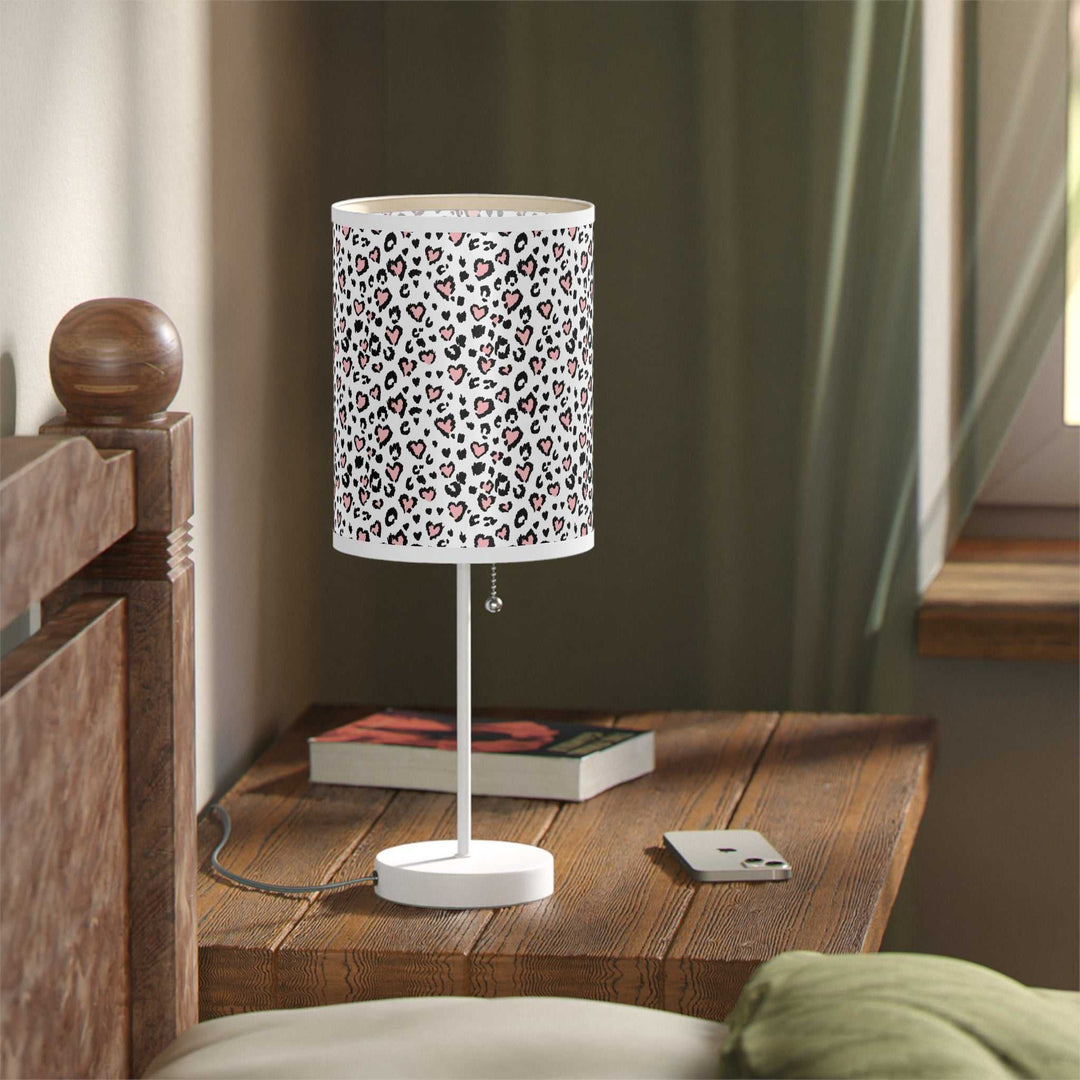 Leopard Hearts Lamp with white steel base and high-resolution printed shade featuring heart-patterned leopard print on bedside table