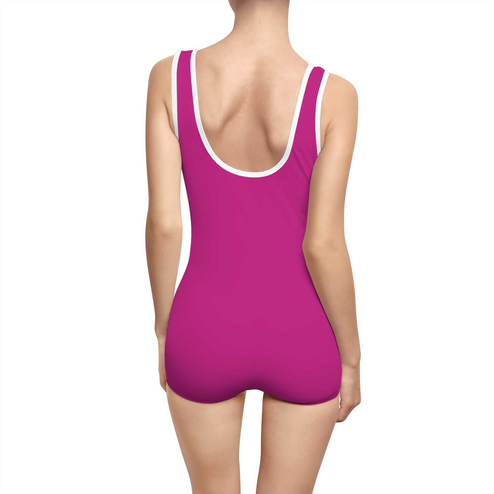 Woman wearing a custom pink Good Vibes Vintage Swimsuit with deep U-back and white trim
