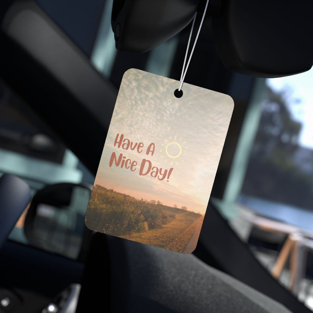Good Day car air freshener with scenic print hanging inside car interior