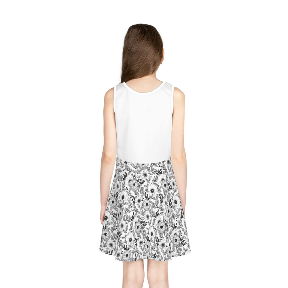 Back view of a sleeveless sundress with a white top and a black and white floral A-line skirt on a girl
