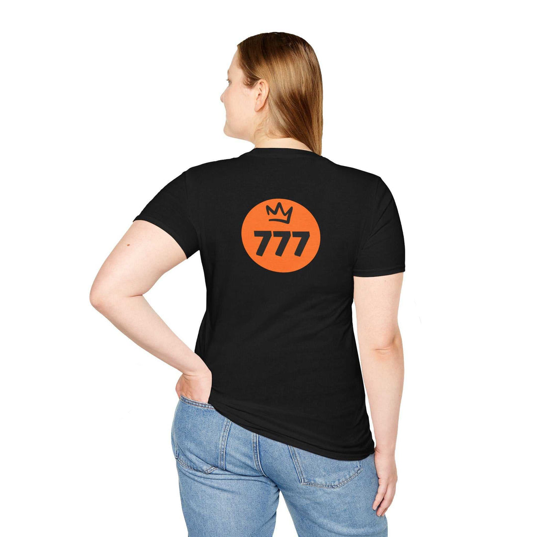 Woman wearing black Divine Perfection t-shirt with orange 777 logo and crown on back, paired with blue jeans