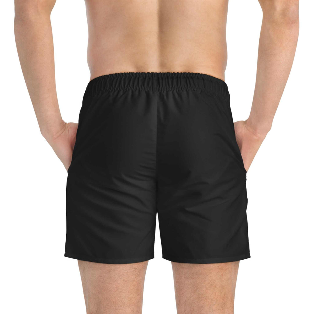 Back view of man wearing black Golden Cross Swim Trunks