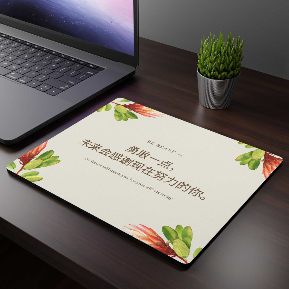 Be Brave motivational mouse pad with floral design on desk next to laptop and plant