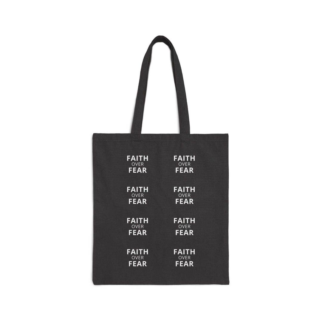 Black cotton canvas tote bag with repeated white "Faith Over Fear" text design