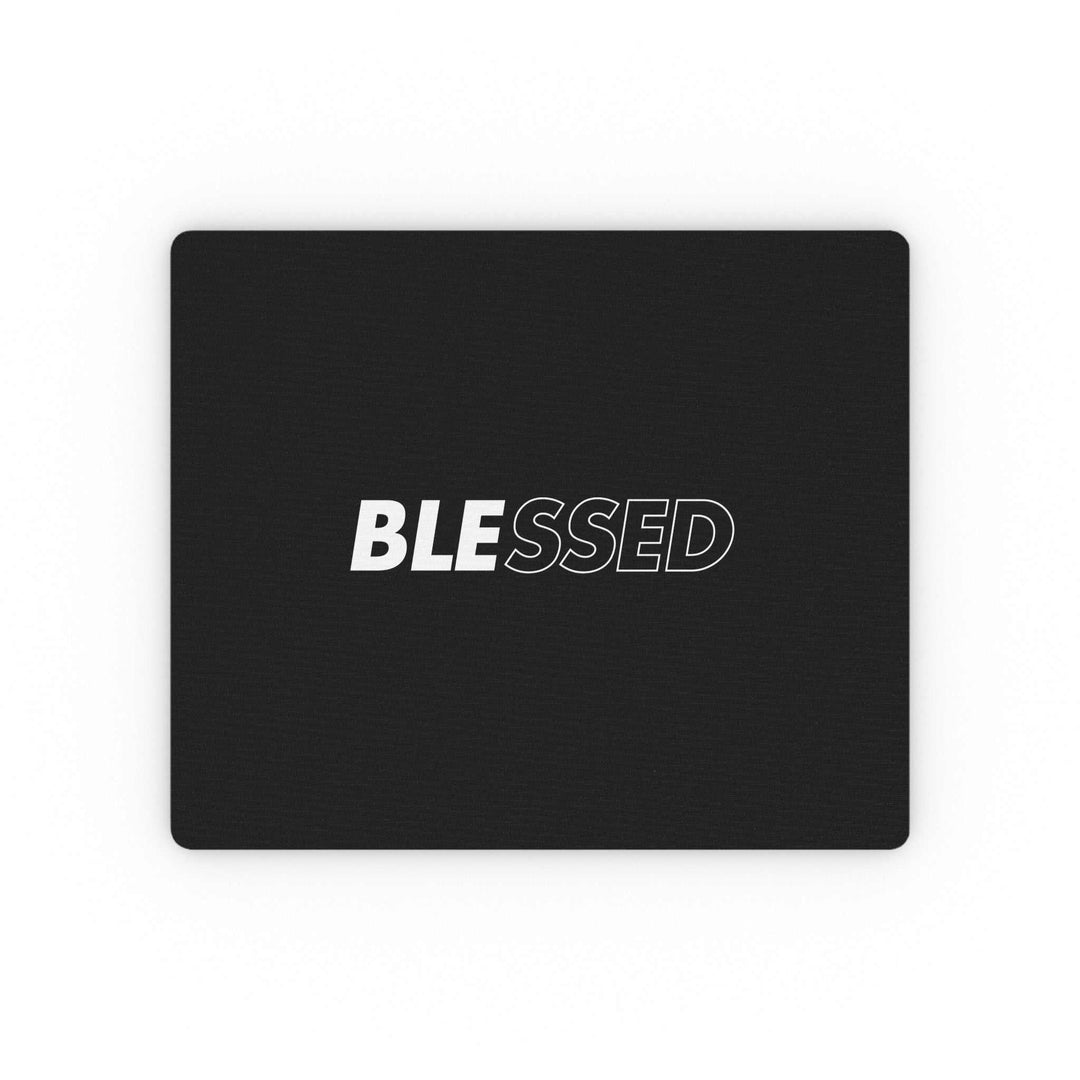 Black mouse pad with the word "BLESSED" in bold white and outlined letters, featuring a durable cloth surface and non-slip rubber backing.