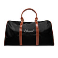 Black Blessed travel bag with brown PU leather handles and gold zipper, made of durable nylon material.