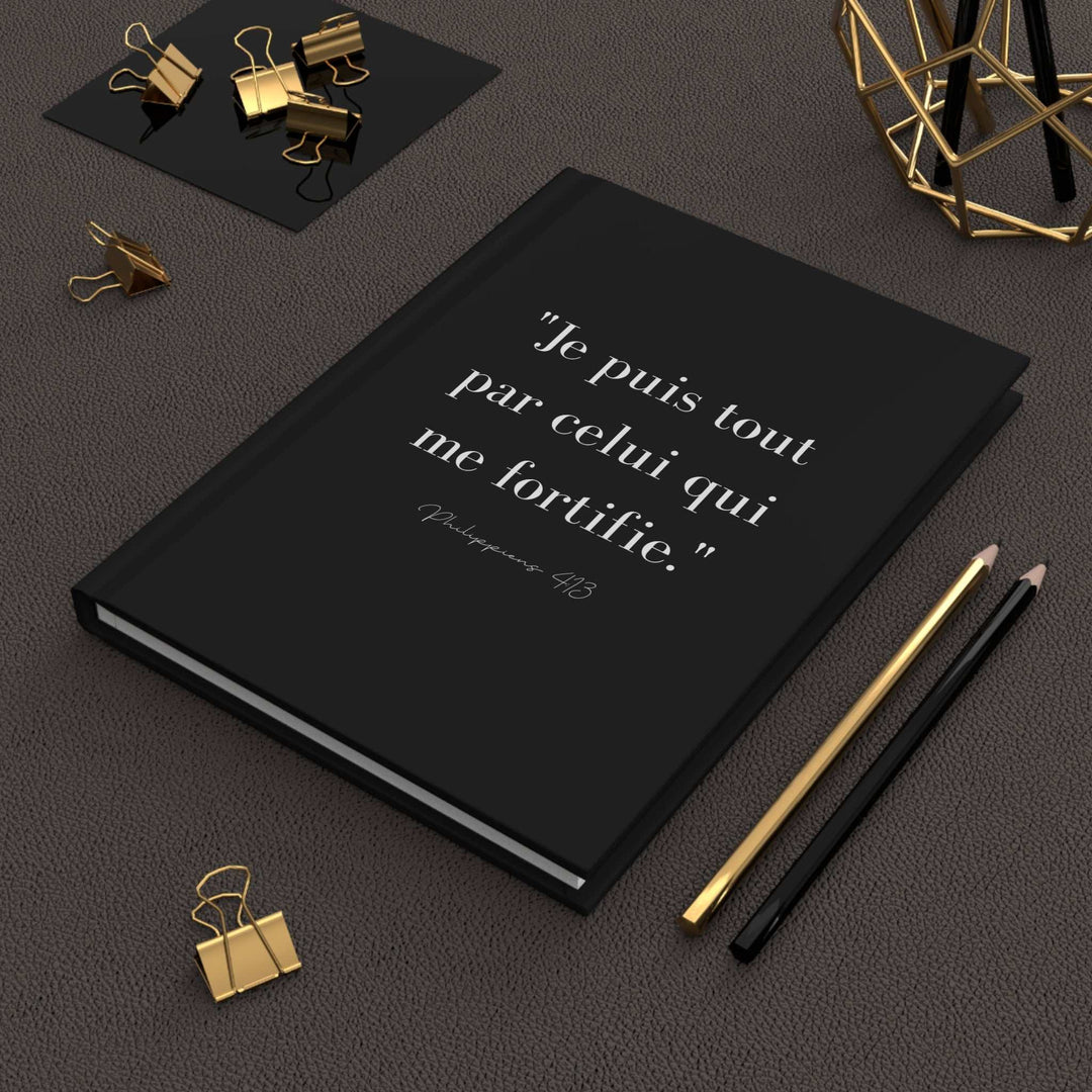 Black matte journal with French Bible verse on cover, featuring 150 lined pages and casewrap binding for faith reflections and spiritual growth.