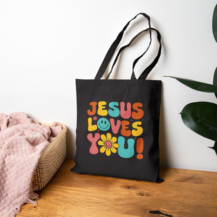Black God’s Love Tote Bag with colorful "Jesus Loves You!" design