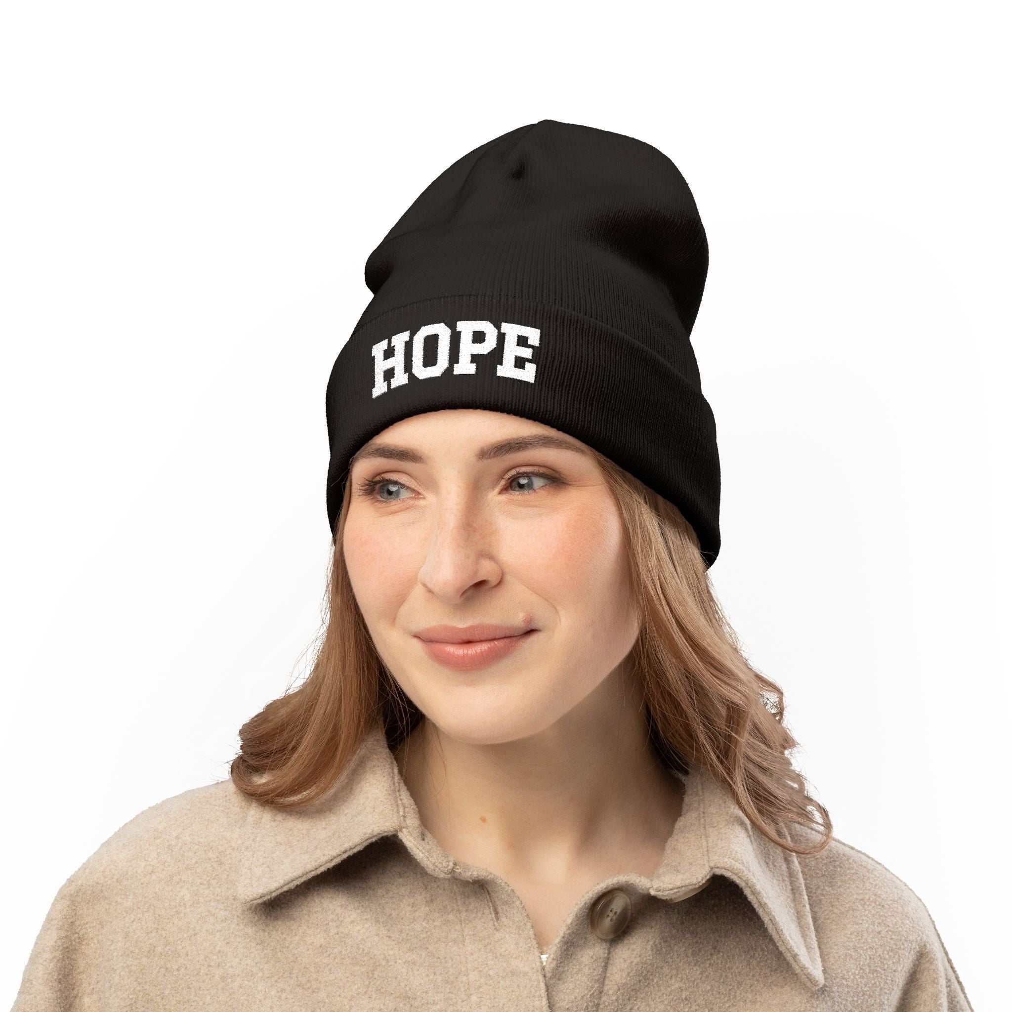 Black Hope Knit Beanie with white embroidered text worn by woman