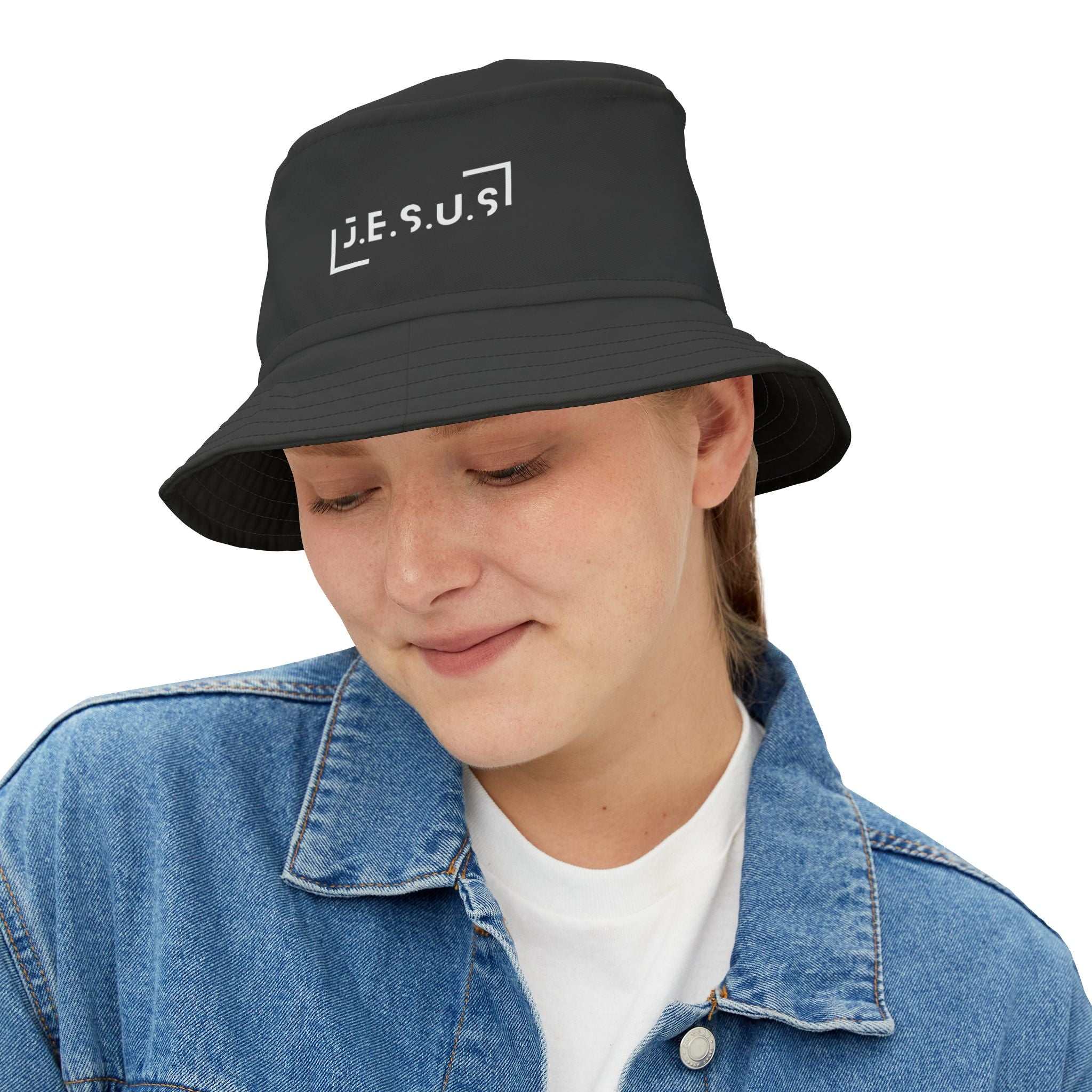 Black Jesus bucket hat made of 100% polyester, worn by a smiling person in a denim jacket