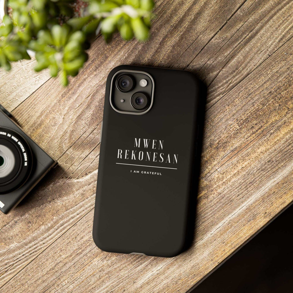 Black Mwen Rekonesan phone case with Haitian Creole gratitude message and matte finish on wooden surface