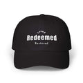 Black Redeemed Cap with embroidered "Loved Redeemed Restored" text, adjustable strap, and cotton blend fabric