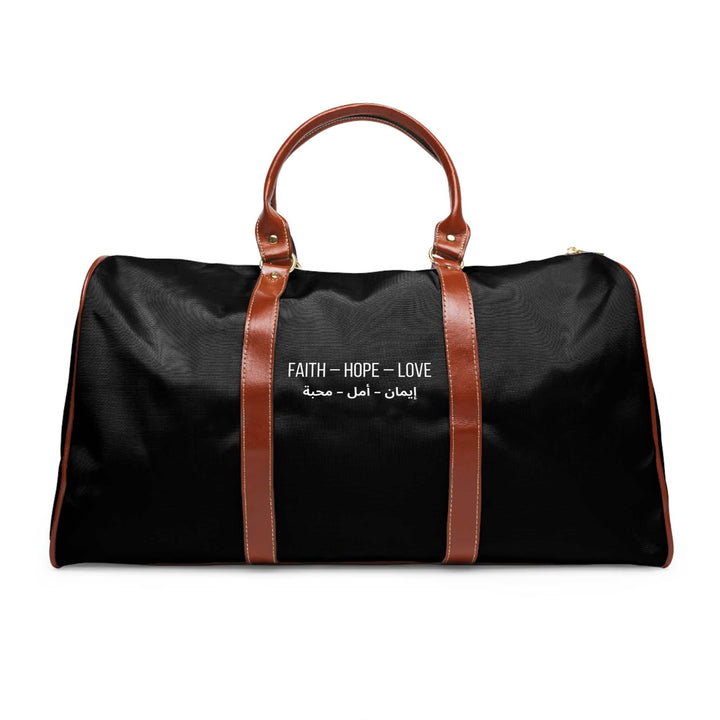 Black travel bag with brown leather handles and "Faith Hope Love" text design