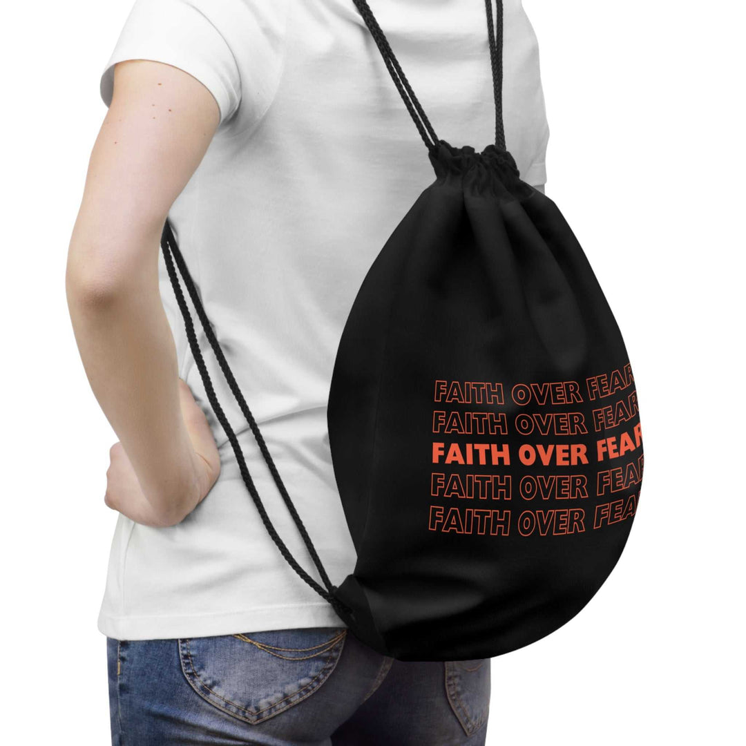 Black Faith Over Fear drawstring bag with bold text, lightweight and practical design, worn on back