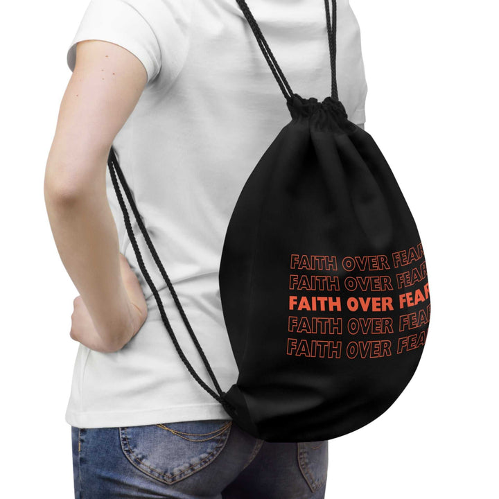 Black Faith Over Fear drawstring bag with bold text, lightweight and practical design, worn on back