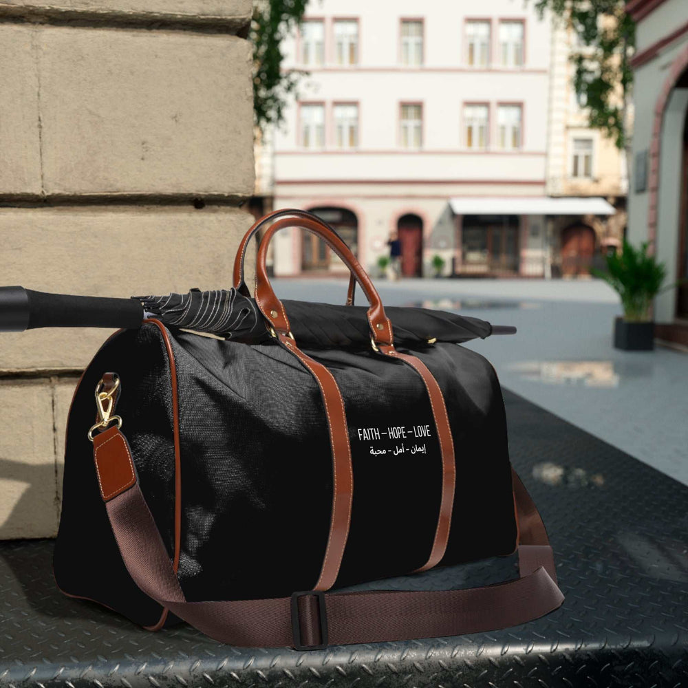 Black Faith Hope Love travel bag with brown PU leather handles and adjustable shoulder strap, gold zipper, and nylon material design