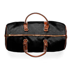 Black travel bag with brown PU leather handles, gold zipper, and nylon material design