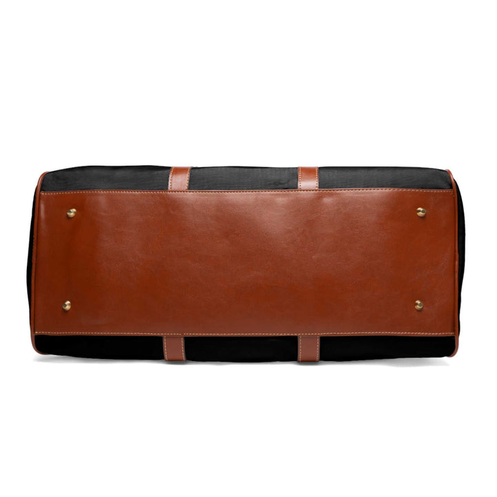 Bottom view of the Blessed travel bag showing brown PU leather base with protective feet and black nylon sides