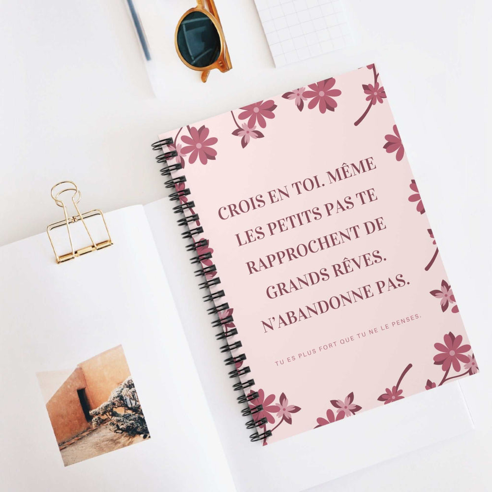Pink floral spiral-bound notebook with French motivational quote on cover