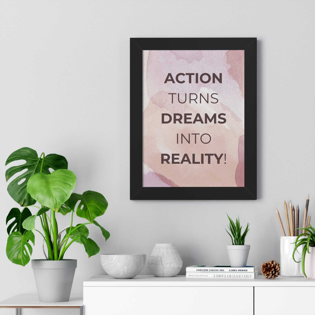 Motivational Dream to Reality poster with bold text in black frame on wall above modern white shelf decorated with plants and books