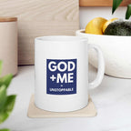 White ceramic faith-based mug with "GOD + ME = UNSTOPPABLE" text, 11oz size, glossy finish, and C-shaped handle