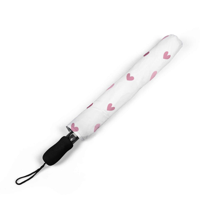 Folded pink hearts pattern umbrella with black rubber handle