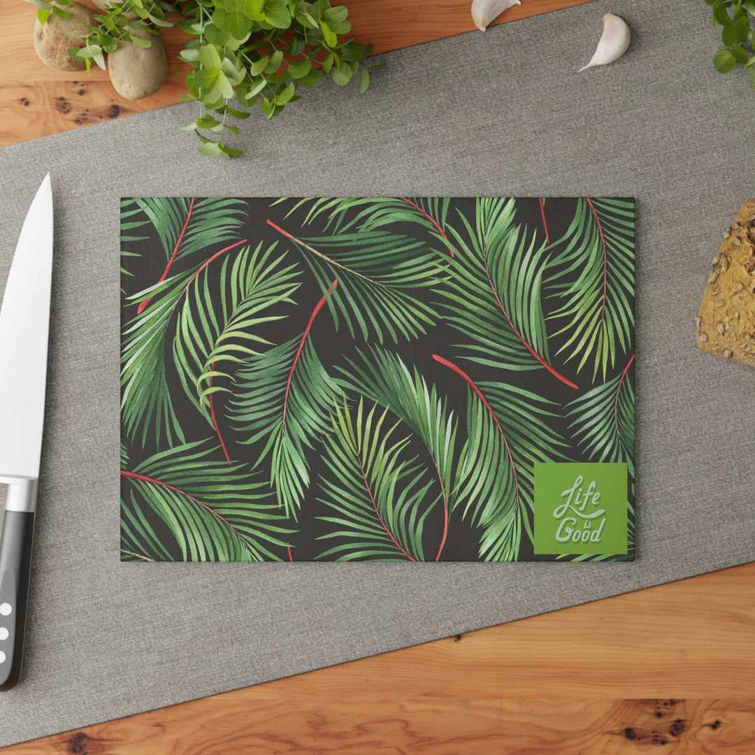Glass cutting board with green palm leaf design and "Life is Good" label