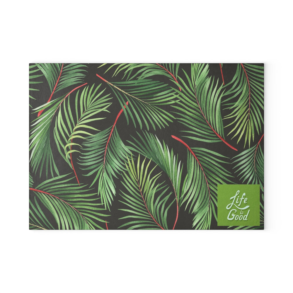 Glass cutting board with green tropical leaf design and Life is Good logo