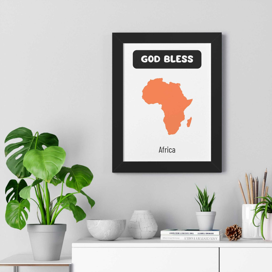 God Bless Africa poster with orange Africa map and black frame on wall above white shelf with plants and decor items