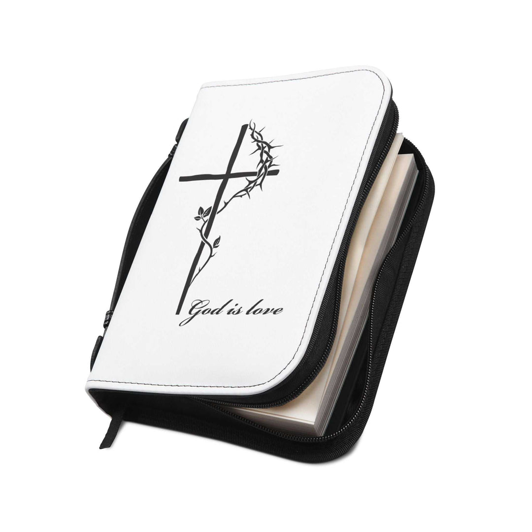White PU leather Bible cover with black cross and "God is love" text, black handle, zipper, and stitching, fits most Bibles.