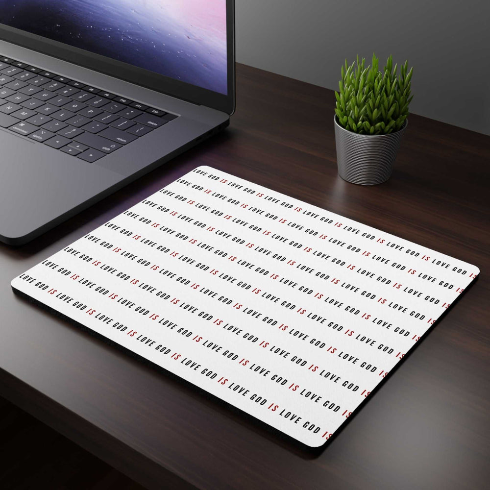 God Is Love mouse pad with inspirational message on white background next to laptop and plant