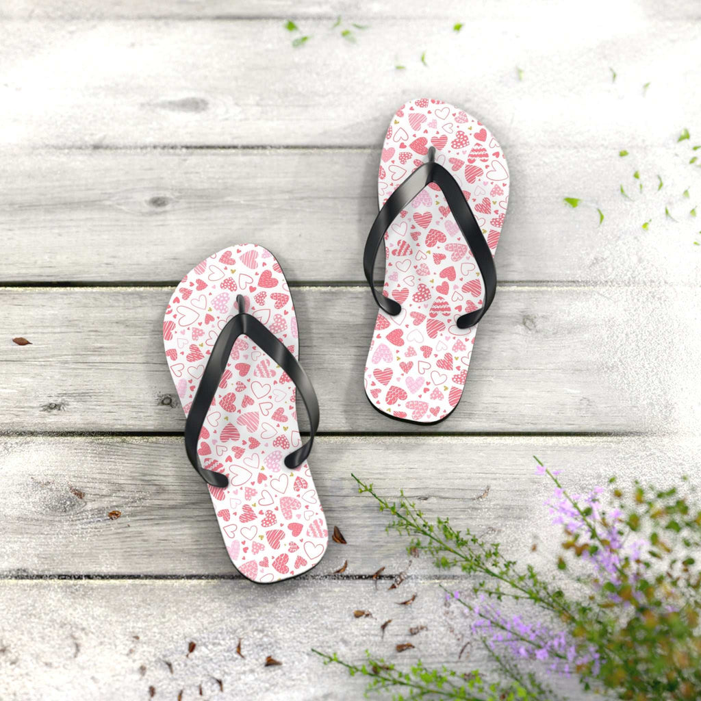 Heart pattern flip flops with black straps and cushioned white sole