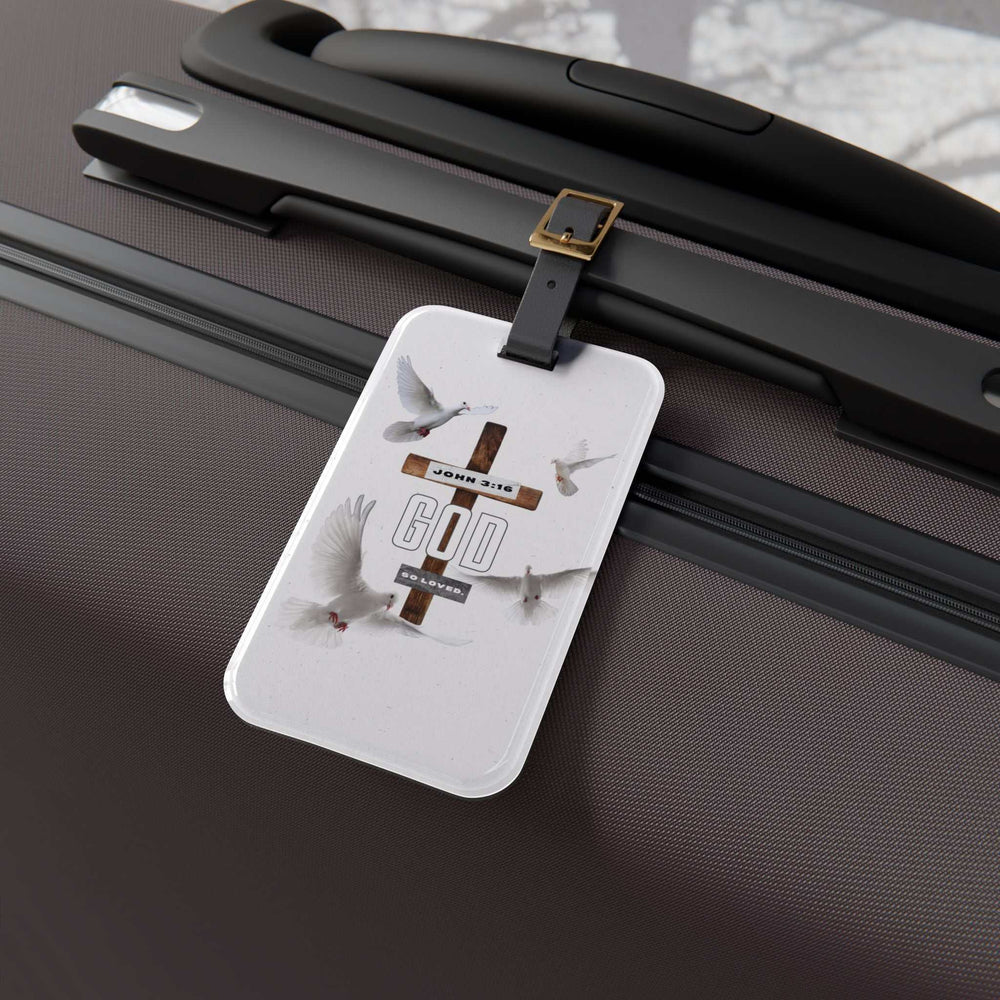 John 3:16 luggage tag with cross and doves attached to suitcase handle with leather strap