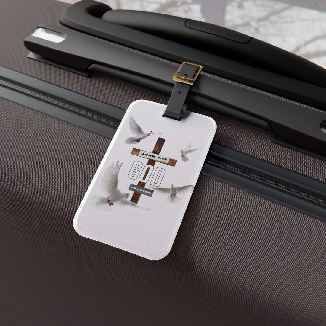 John 3:16 luggage tag with cross and doves attached to suitcase handle with leather strap
