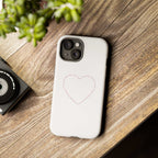 White Love Wins phone case with heart design on wooden surface, durable dual-layer protection phone case